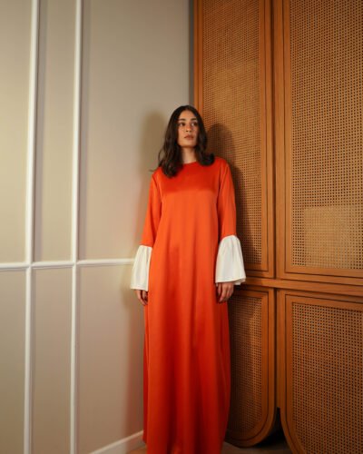 Laisser-vous double satin abaya in beautiful burnt orange fluid color with creamy trim puffed cuffs